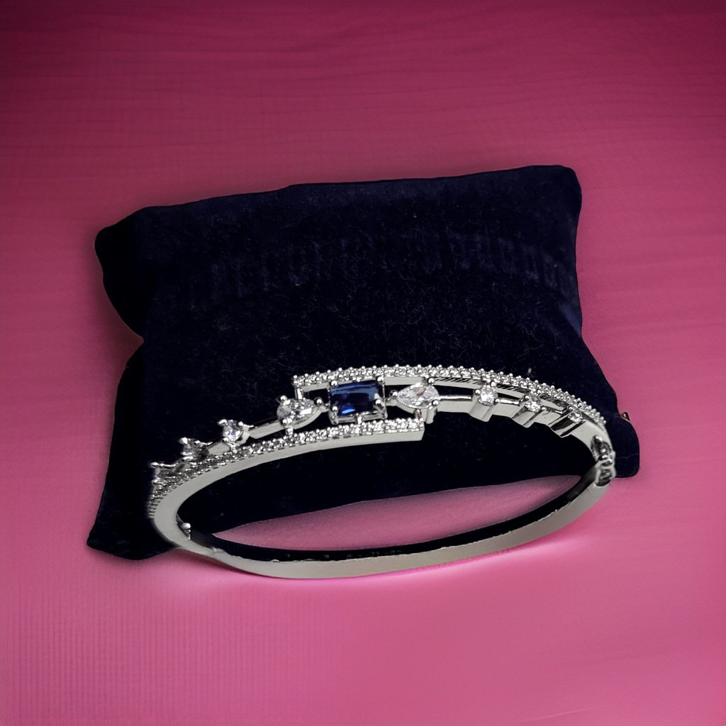 Make a statement with our Aura Blue Diamond Look Bracelet. Crafted with attention to detail, this bracelet features a captivating blue diamond-like design that exudes elegance. The adjustable clasp ensures a comfortable fit, making it suitable for everyday wear or special occasions.