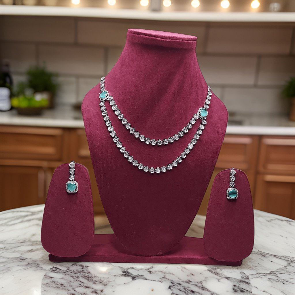 Elevate your look with our Crystal Tassel Multi Layer American Diamond Necklace. This elegant piece features multi-layered chains with crystal tassel accents for a glamorous look. The adjustable length ensures a perfect fit, making it suitable for all necklines.