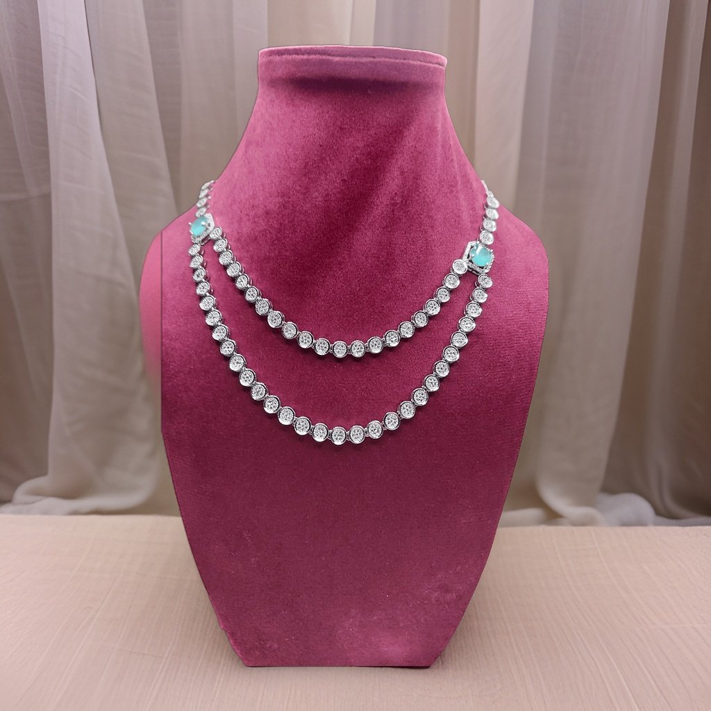 Elevate your look with our Crystal Tassel Multi Layer American Diamond Necklace. This elegant piece features multi-layered chains with crystal tassel accents for a glamorous look. The adjustable length ensures a perfect fit, making it suitable for all necklines.