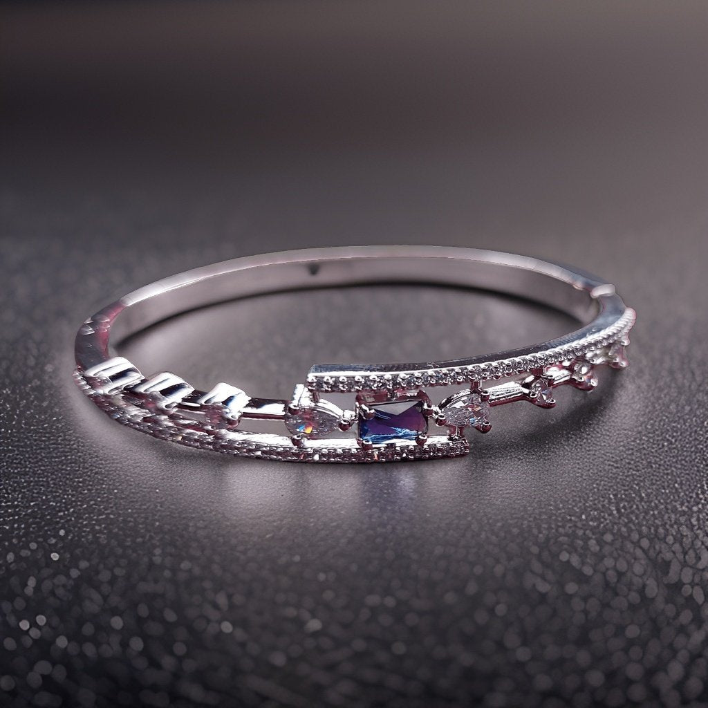 Make a statement with our Aura Blue Diamond Look Bracelet. Crafted with attention to detail, this bracelet features a captivating blue diamond-like design that exudes elegance. The adjustable clasp ensures a comfortable fit, making it suitable for everyday wear or special occasions.