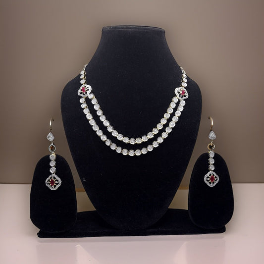 Make a bold statement with our Red Silver American Diamond Necklace. This eye-catching piece features sparkling red American diamond accents that catch the light beautifully. The adjustable length ensures a comfortable fit, making it suitable for all occasions.