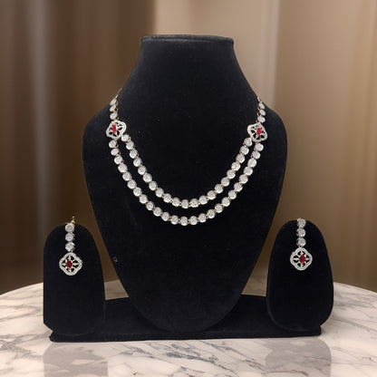 Make a bold statement with our Red Silver American Diamond Necklace. This eye-catching piece features sparkling red American diamond accents that catch the light beautifully. The adjustable length ensures a comfortable fit, making it suitable for all occasions.