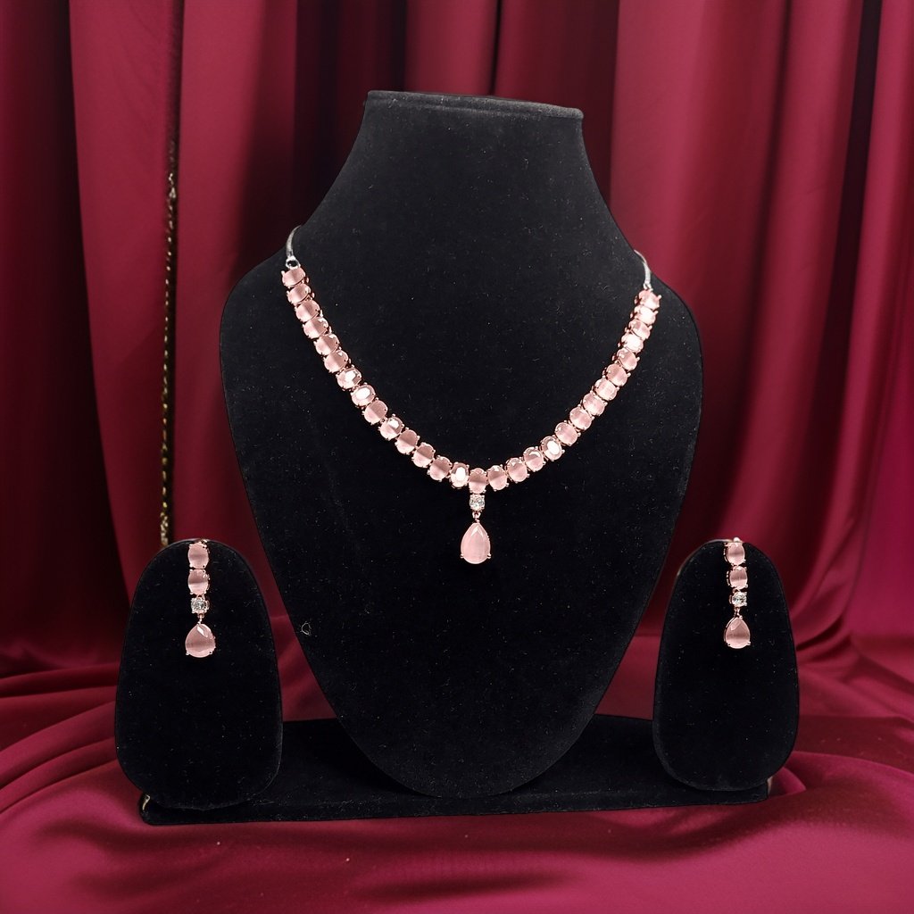 Add a touch of femininity to your ensemble with our Round and Pear Cut Pink Necklace. This stylish piece features round and pear-cut pink accents that add a pop of color to any look. The adjustable length ensures a comfortable fit, making it suitable for all occasions.