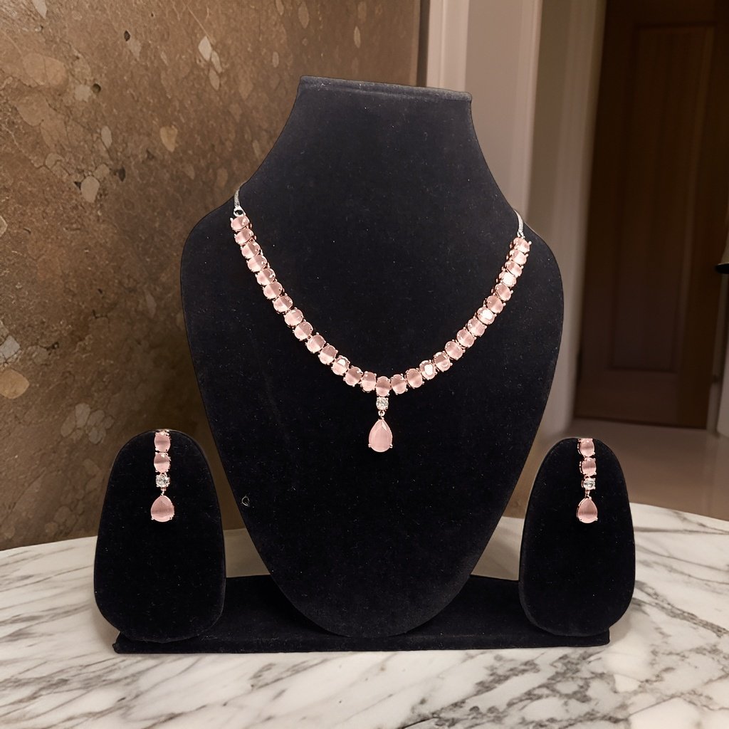 Add a touch of femininity to your ensemble with our Round and Pear Cut Pink Necklace. This stylish piece features round and pear-cut pink accents that add a pop of color to any look. The adjustable length ensures a comfortable fit, making it suitable for all occasions.